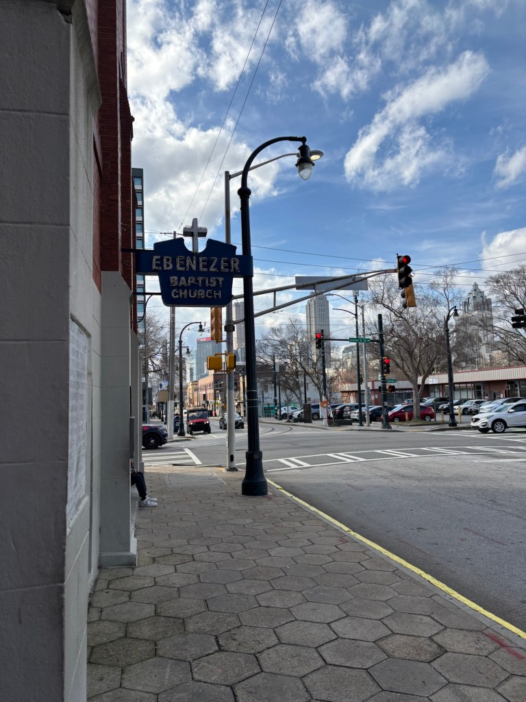 Street corner with a sign for Ebenezer Baptist Church.